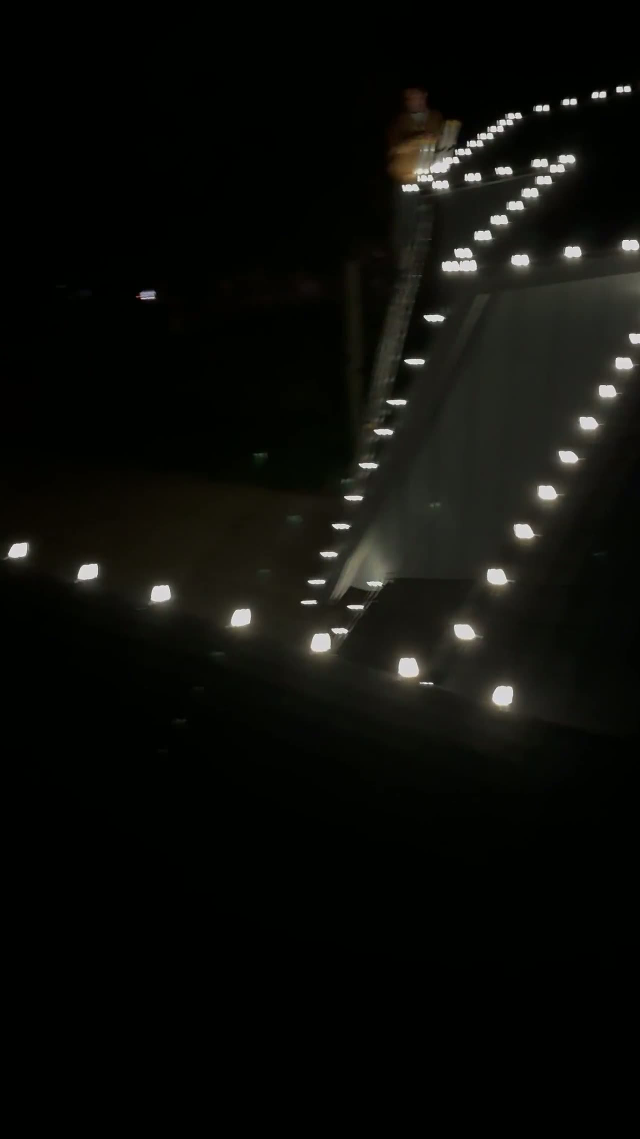 Short evening clip of a finished roofline install glowing against a dark sky